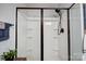 Shower stall featuring a built-in shelving unit with a bronze shower head and door frame at 3018 Corinth Church Rd, Monroe, NC 28112