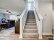 Stairway with carpeted steps featuring a white banister and open floor plan with living room at 3018 Corinth Church Rd, Monroe, NC 28112