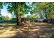 Backyard with house, hammock, and large trees at 3401 Stony Brook Cir, Newton, NC 28658