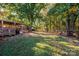 Large backyard with playset, covered patio, and mature trees at 3401 Stony Brook Cir, Newton, NC 28658