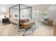 Main bedroom with a four-poster bed and light hardwood floors at 7062 Quail Hill Rd, Charlotte, NC 28210