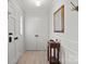 Entryway with wood flooring, coat rack, and mirror at 7062 Quail Hill Rd, Charlotte, NC 28210