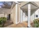 Front entrance of a tan colored townhouse with a small porch at 7062 Quail Hill Rd, Charlotte, NC 28210