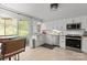 Modern kitchen with white shaker cabinets, stainless steel appliances, and light wood countertops at 7062 Quail Hill Rd, Charlotte, NC 28210