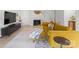 Bright living room featuring a mustard yellow sectional sofa and a modern fireplace at 7062 Quail Hill Rd, Charlotte, NC 28210