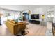 Open living space with hardwood floors, a mustard yellow couch, and a view into the kitchen at 7062 Quail Hill Rd, Charlotte, NC 28210