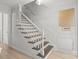 Clean and bright staircase with white railings and dark wood steps at 7062 Quail Hill Rd, Charlotte, NC 28210