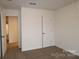 Simple bedroom with carpet, neutral walls, and a door to hallway at 3540 Nimbell Rd, Monroe, NC 28110