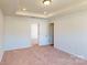 Spacious bedroom with plush carpeting and access to hallway at 3543 Nimbell Rd, Monroe, NC 28110