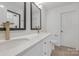 Modern bathroom with double vanity and gold fixtures at 7415 Linda Lake Dr, Charlotte, NC 28215