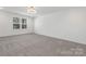 Bright bedroom with grey carpet and large window at 7415 Linda Lake Dr, Charlotte, NC 28215