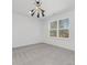 Well-lit bedroom, featuring a large window and modern light fixture at 7415 Linda Lake Dr, Charlotte, NC 28215