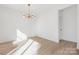 Bright dining room features hardwood floors and a modern chandelier at 7415 Linda Lake Dr, Charlotte, NC 28215