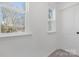 Bright hallway with two windows and a door at 7415 Linda Lake Dr, Charlotte, NC 28215