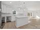 Modern white kitchen with stainless steel appliances and island at 7415 Linda Lake Dr, Charlotte, NC 28215