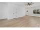 Open living area with light hardwood floors and access to entryway at 7415 Linda Lake Dr, Charlotte, NC 28215