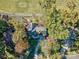 Overhead view of the charming house nestled among mature trees, with a golf course nearby at 94 Heritage Dr, Lake Wylie, SC 29710