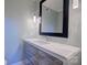 Modern bathroom featuring floating vanity with gray wood-look drawers, countertop, and a large mirror at 94 Heritage Dr, Lake Wylie, SC 29710