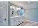 Bathroom featuring a dual vanity with bright mirrors and warm wood-look flooring at 94 Heritage Dr, Lake Wylie, SC 29710