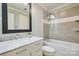 Updated bathroom with a tub-shower, glass partition, tiled walls, and a vanity with marble countertop at 94 Heritage Dr, Lake Wylie, SC 29710
