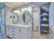 Bright bathroom featuring double vanity with round mirrors and a beautifully tiled walk-in shower at 94 Heritage Dr, Lake Wylie, SC 29710