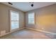 Cozy bedroom with two windows providing natural light and neutral-toned walls and carpet at 94 Heritage Dr, Lake Wylie, SC 29710