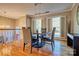 Sunlit dining area showcasing hardwood floors and large windows with charming white shutters at 94 Heritage Dr, Lake Wylie, SC 29710