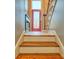 Stylish entryway features hardwood stairs and a vibrant red glass-paneled front door at 94 Heritage Dr, Lake Wylie, SC 29710