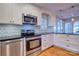 Beautiful kitchen featuring stainless steel appliances, bright white cabinets and granite countertops at 94 Heritage Dr, Lake Wylie, SC 29710