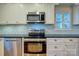 Modern kitchen featuring stainless steel appliances, light backsplash, and bright natural light at 94 Heritage Dr, Lake Wylie, SC 29710