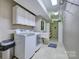 Laundry room with washer, dryer, sink, and cabinets for storage at 94 Heritage Dr, Lake Wylie, SC 29710
