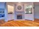 Cozy living room with a decorative fireplace, hardwood floors, and built-in cabinets at 94 Heritage Dr, Lake Wylie, SC 29710