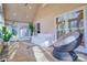 Bright sunroom with vaulted ceiling, tile flooring and wicker papasan chair at 94 Heritage Dr, Lake Wylie, SC 29710