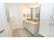 Bright bathroom with double sinks, granite counters, stylish tile flooring, and white storage cabinets at 126 Fleming Dr, Statesville, NC 28677