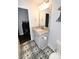Bathroom with granite countertop, grey cabinetry, patterned tile flooring and modern mirror, blending style and function at 126 Fleming Dr, Statesville, NC 28677