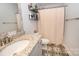 Bathroom with modern sink, patterned tile floor, and shower curtain, combining style and functionality at 126 Fleming Dr, Statesville, NC 28677
