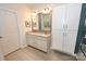 Bright bathroom with double sinks, granite counters, stylish tile flooring, and white storage cabinets at 126 Fleming Dr, Statesville, NC 28677