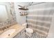 Cozy bathroom featuring decorative patterned flooring, granite vanity, and stylish open shelving at 126 Fleming Dr, Statesville, NC 28677