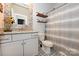 Cozy bathroom featuring decorative patterned flooring, granite vanity, and stylish open shelving at 126 Fleming Dr, Statesville, NC 28677