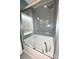 A bright bathroom with a large tub, sleek glass doors, and stylish blue-tiled shower with built in nooks at 126 Fleming Dr, Statesville, NC 28677