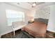 Bedroom showcases a window-side loveseat, patterned accent wall, and a plush bed for a soothing retreat at 126 Fleming Dr, Statesville, NC 28677