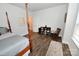 Bright bedroom featuring hardwood floors, a four-poster bed and a decorative rocking chair at 126 Fleming Dr, Statesville, NC 28677