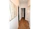 Bright hallway featuring wood-look flooring and an artistic tree painting on the wall at 126 Fleming Dr, Statesville, NC 28677