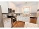 Well-lit kitchen with granite counters, stainless appliances, and white cabinetry for a modern feel at 126 Fleming Dr, Statesville, NC 28677