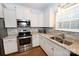 Modern kitchen with stainless steel appliances, granite countertops, and stylish tile backsplash at 126 Fleming Dr, Statesville, NC 28677