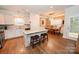 Bright kitchen features an island with granite countertops, white cabinets, and stainless steel appliances at 126 Fleming Dr, Statesville, NC 28677