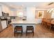 Open kitchen features a large island, stainless appliances, and a view of the adjacent dining area at 126 Fleming Dr, Statesville, NC 28677