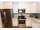 Updated kitchen featuring stainless steel appliances, granite counters, and ample cabinet storage space at 126 Fleming Dr, Statesville, NC 28677