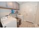 Functional laundry room with washer, dryer, storage cabinets, and patterned tile flooring at 126 Fleming Dr, Statesville, NC 28677