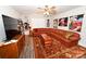 Bright living room with sectional sofa, ceiling fan, wooden furniture, and vibrant rug offers a cozy gathering space at 126 Fleming Dr, Statesville, NC 28677